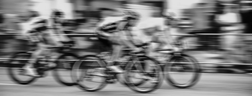 blurred-cyclist-black-and-white