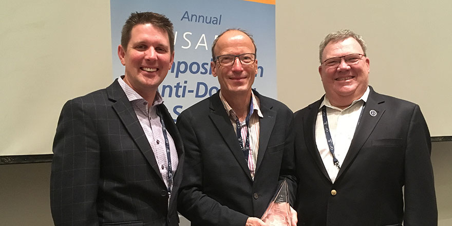 2018 LD Bowers Award winner Dr. Matthias Kamber (center)