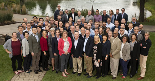 Group shot of all attendees of the 2018 Science Symposium in front of a pond.