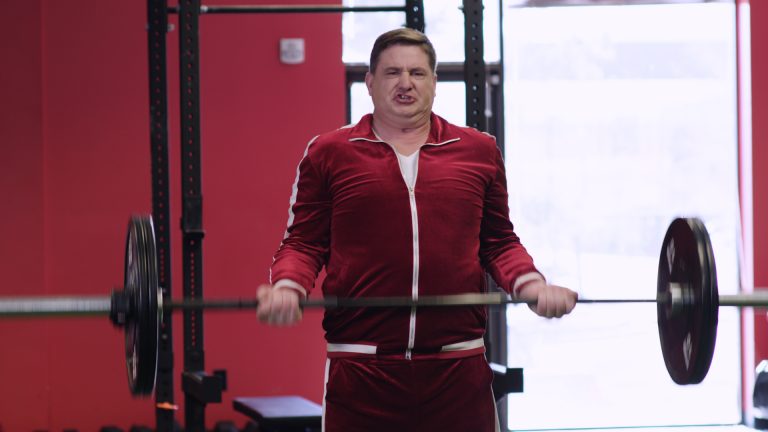 Chaos lifting a barbell in a gym.