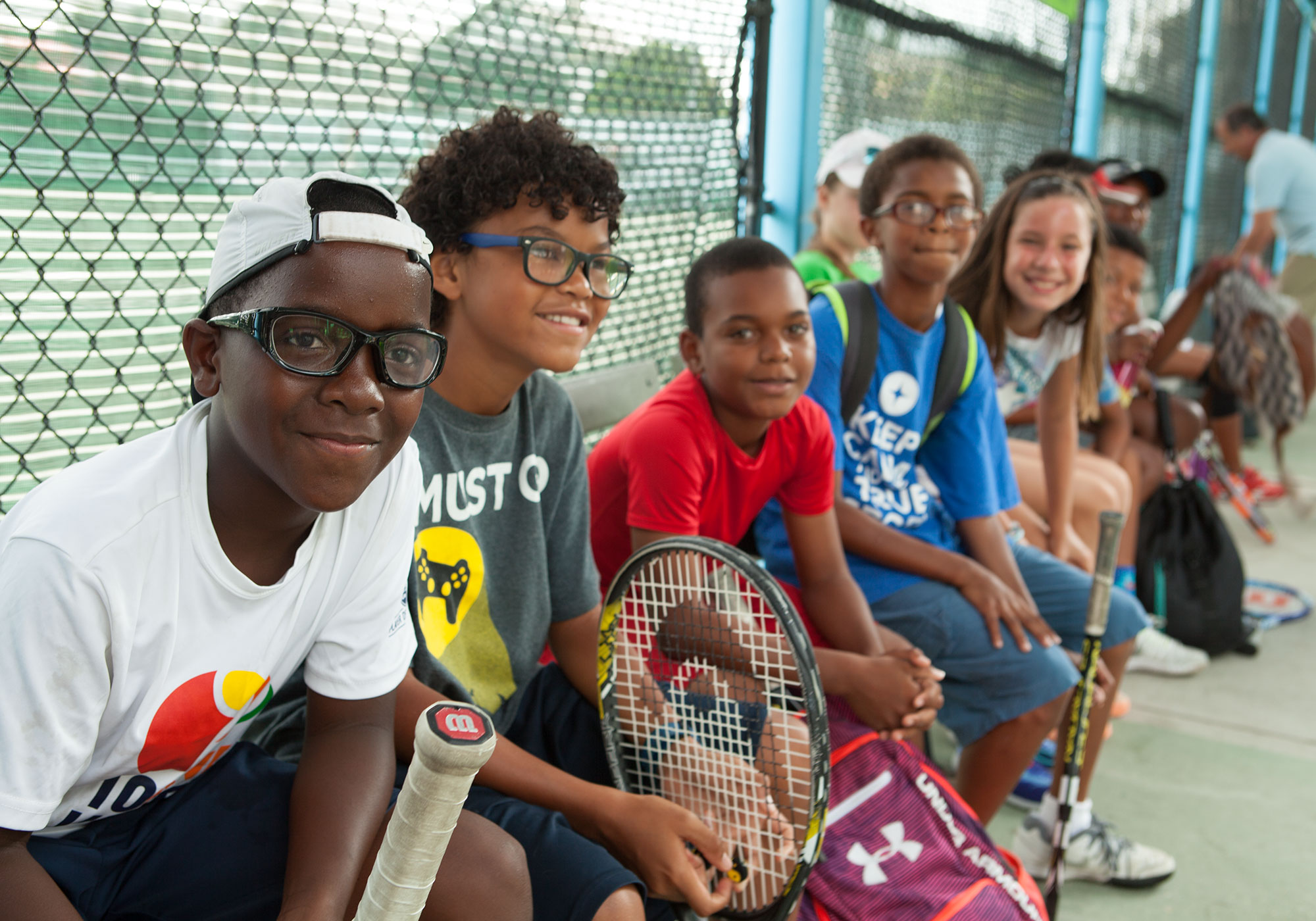 tennis kids sitting on bench