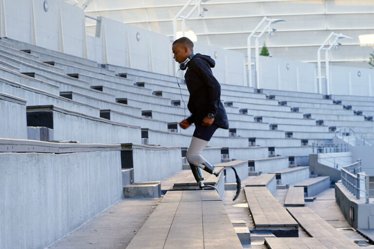 Young male double leg amputee running up stairs.