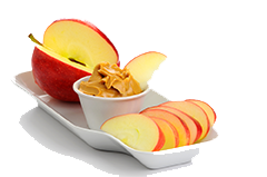 apples and peanut butter on white background