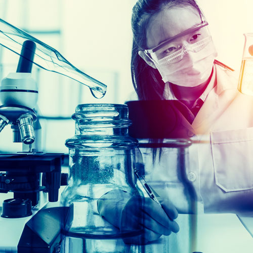 female scientist with beakers