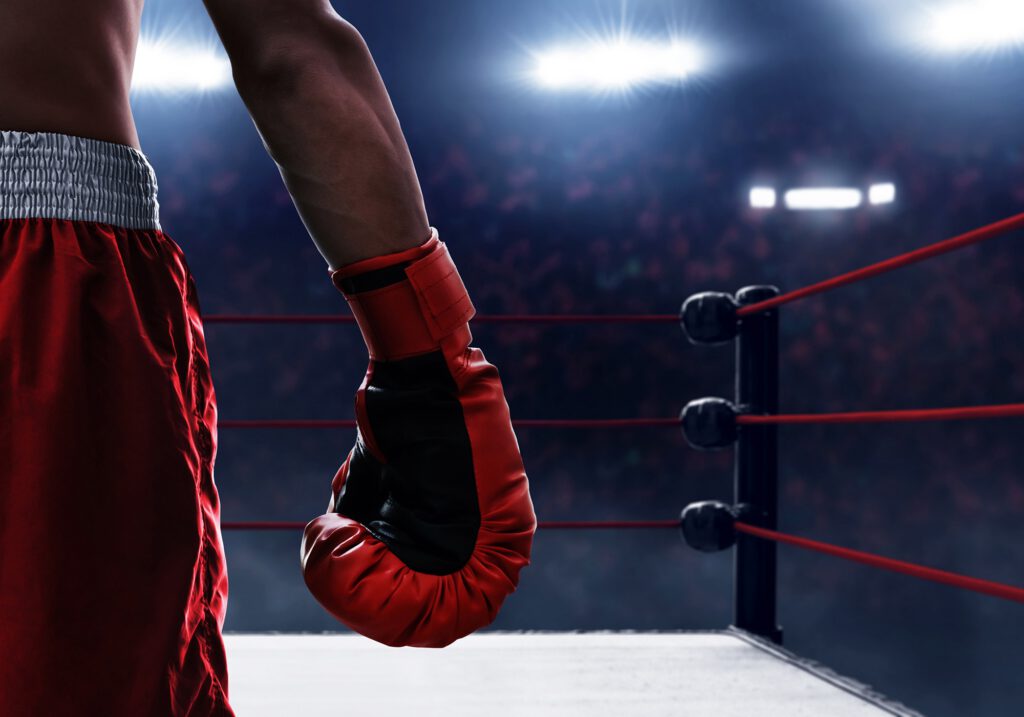 Close up of a man's hand wearing boxing gloves.