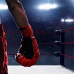 Close up of a man's hand wearing boxing gloves.