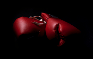 two boxing gloves in the shadows