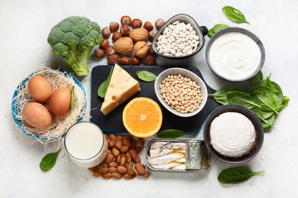 Various foods high in calcium including milk, eggs, broccoli, sardines, and more.