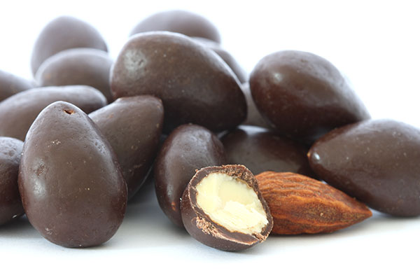 Close up of dark chocolate covered almonds.