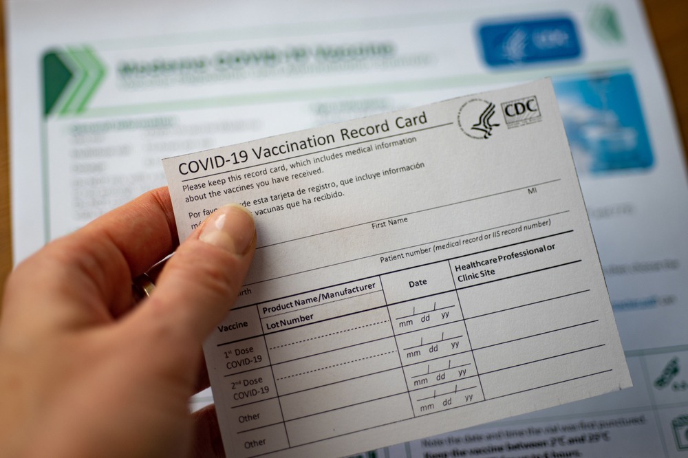 Close up of a CDC COVID-19 vaccination report card.