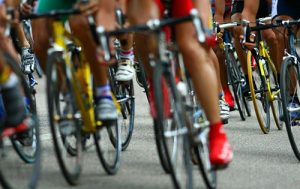 close up of group of cyclists wheels and feet