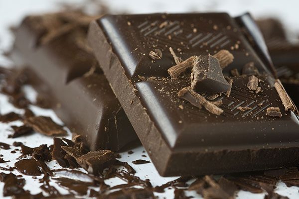 close up of pieces of dark chocolate and shavings