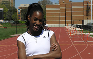 DeeDee Trotter standing on a track.