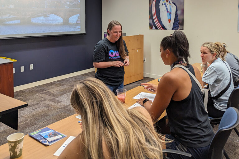 Elite Education Director, Tammy Hanson, talking to athletes at a presentation.