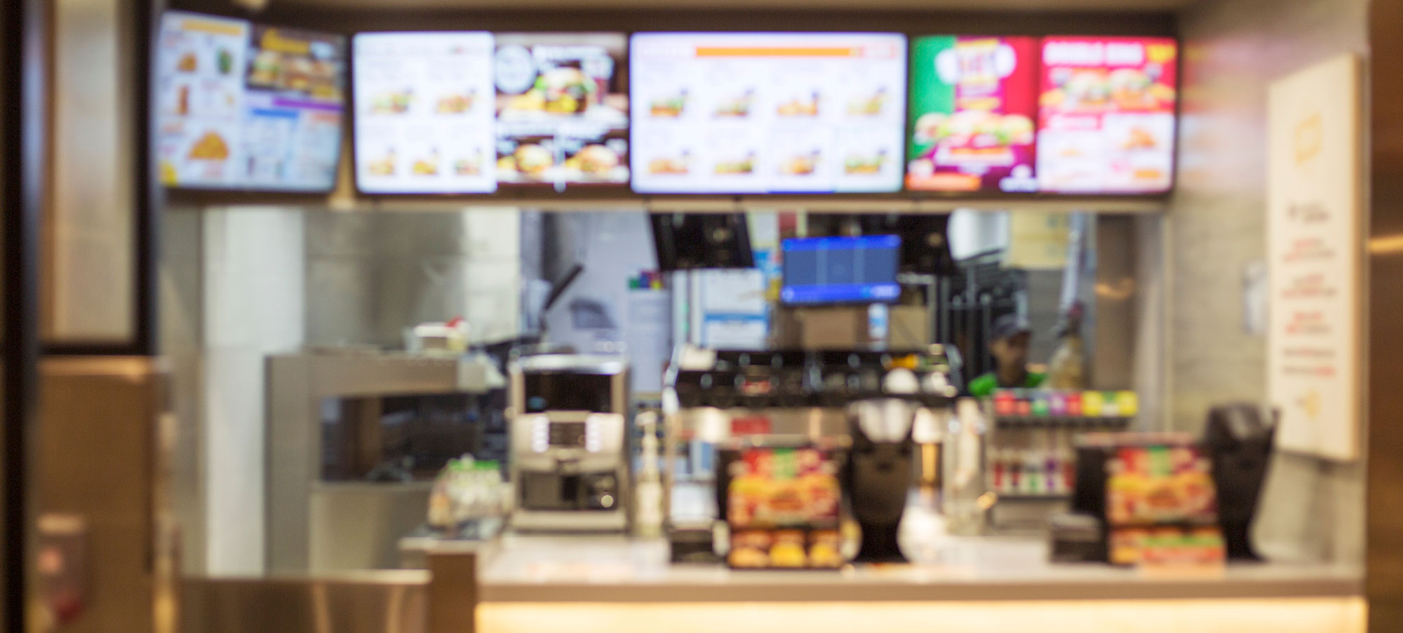 Blurred out image of the inside of a fast food restaurant.