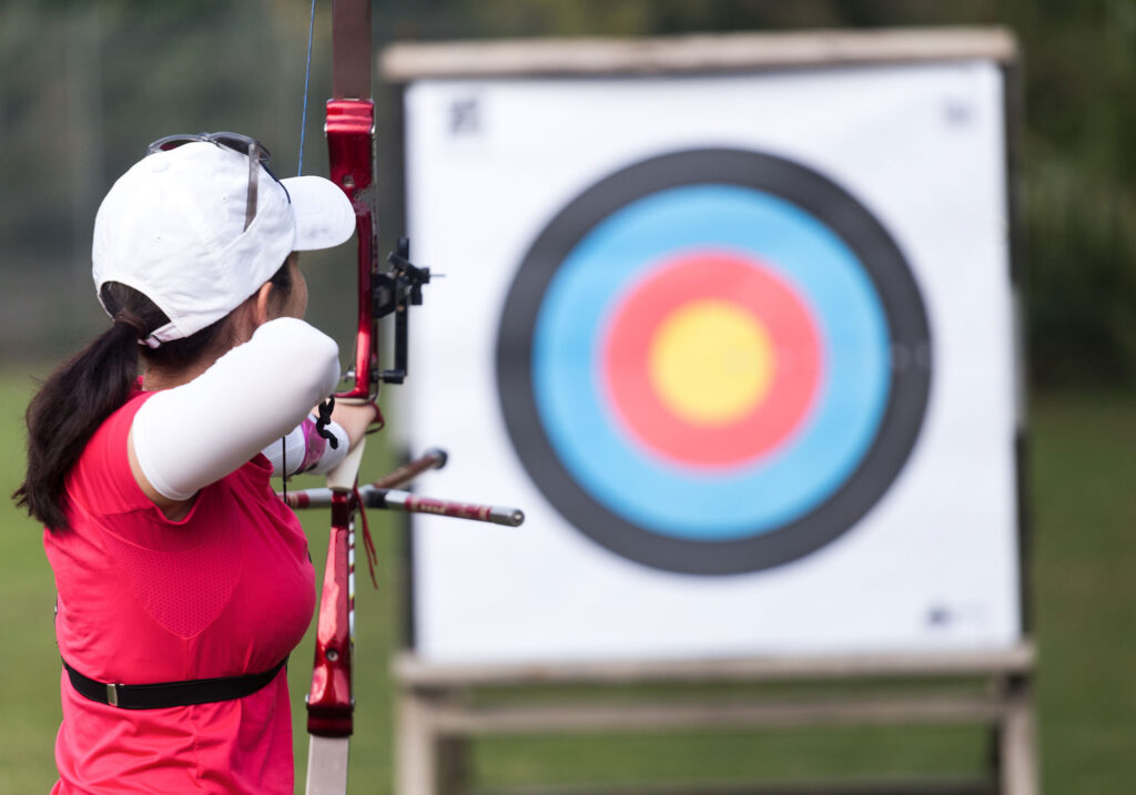 female athlete practicing archery