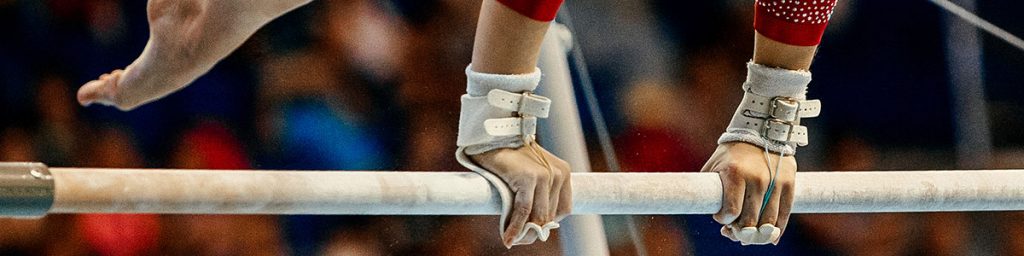 close-up of female gymnastics hands on uneven bars