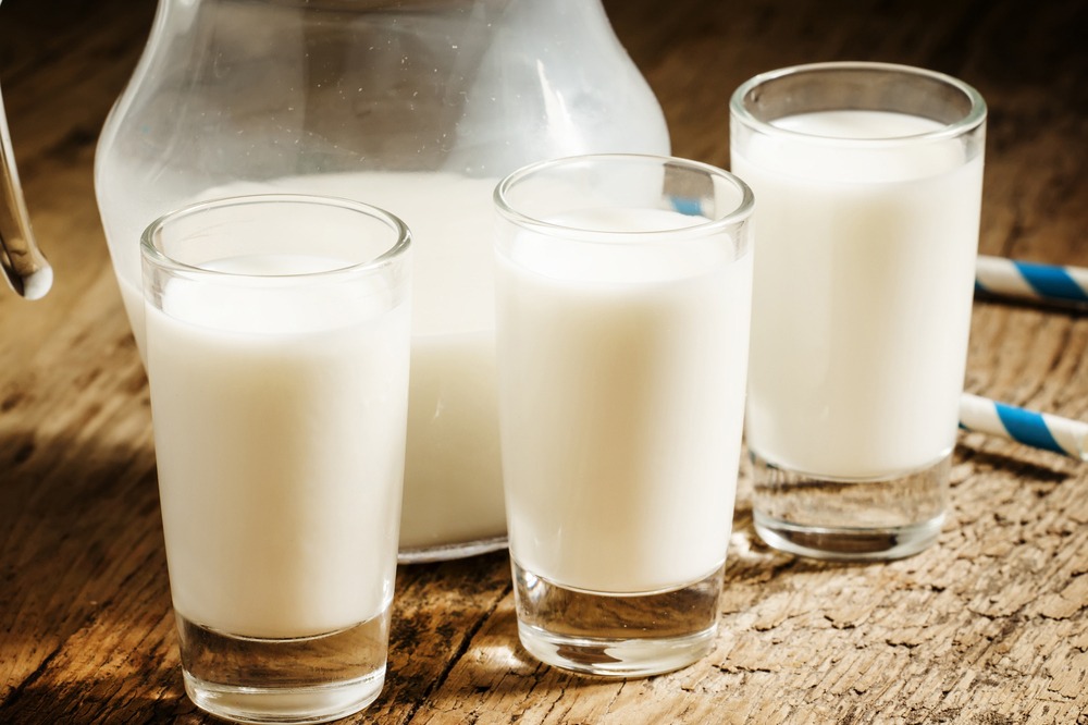Glasses of milk on table.