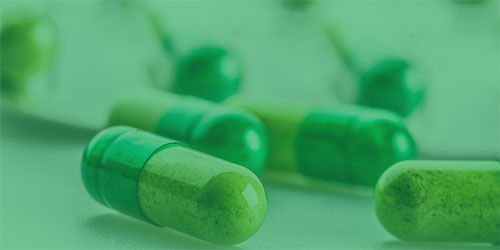 pills on table with green overlay