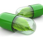green-pills-with-leaves on white background