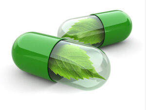 green-pills-with-leaves on white background