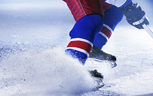 hockey player stopping with ice spraying