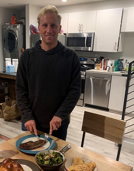 Jordan Wilimovsky cutting a steak.