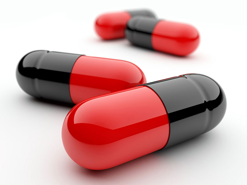 black and red capsule pills