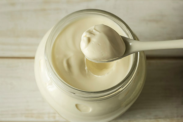 Jar of mayonnaise with spoon.