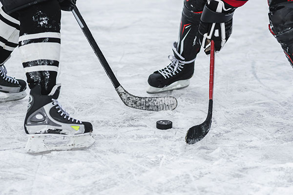 close-up of hockey players feet as they face off