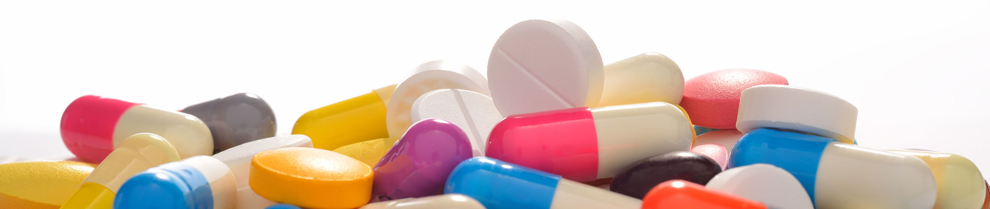multi-colored supplement pills on white background