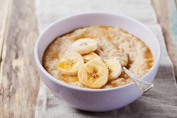 bowl of oatmeal with sliced banana on top
