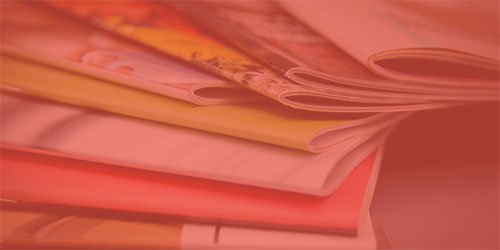 stack of publications with red overlay