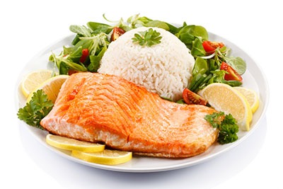 grilled salmon with rice and vegetables on a plate