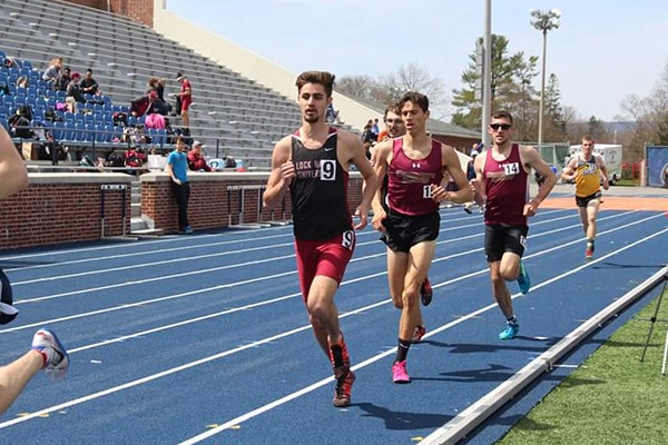 Education team member Scott Davern running in college track meet