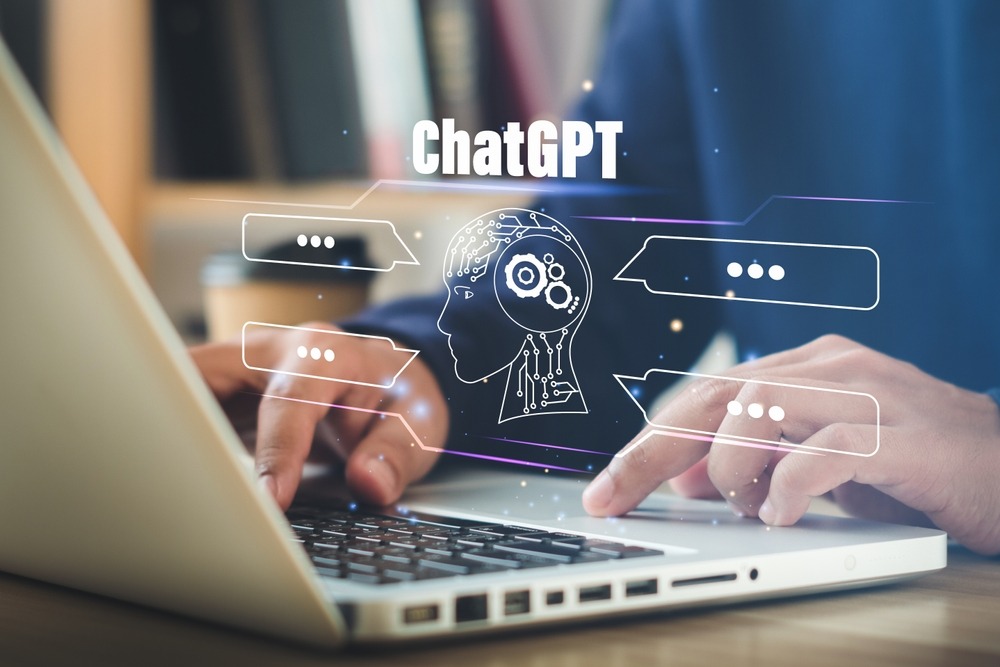 ChatpGPT graphics above someone using a laptop.