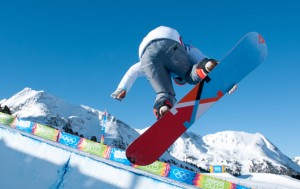 snowboarder in mid-air over half pipe