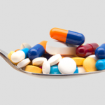 multi colored pills on spoon