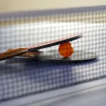 table tennis paddles with ball on table