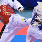 Two athletes competing in taekwondo