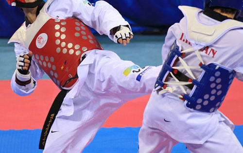 Two athletes competing in taekwondo