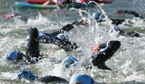 group of people swimming in a triathlon