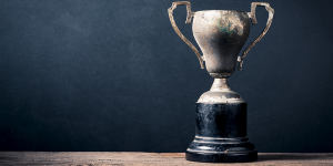 A trophy in front of a black background.