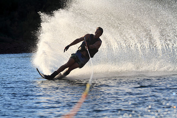 man waterskiing and creating a splash