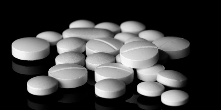 white pills on black background