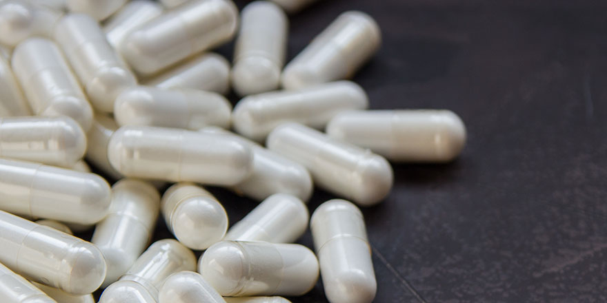 white supplements on black table
