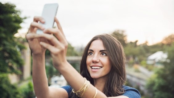 woman taking selfie with cell phone