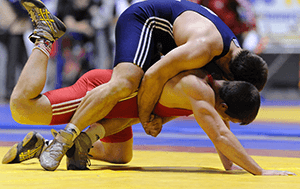 two male wrestlers in the middle of a match